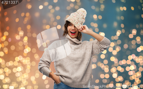 Image of young woman in knitted winter hat and sweater