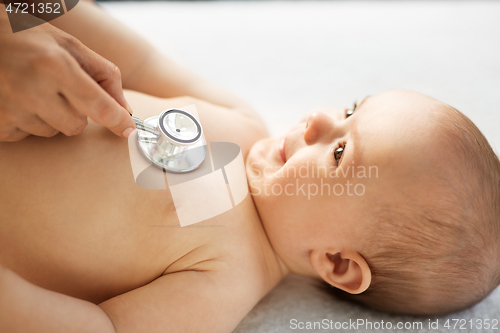 Image of doctor with stethoscope listening to baby patient