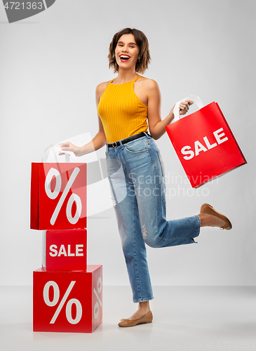 Image of happy smiling young woman with shopping bags