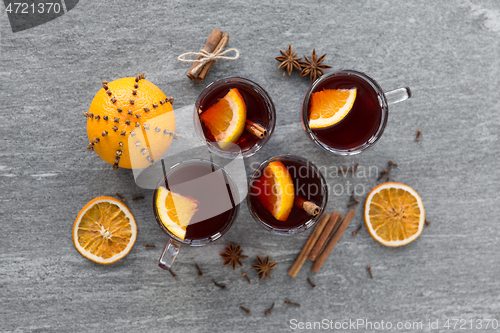 Image of hot mulled wine, orange slices, raisins and spices