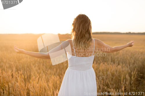 Image of happy woman enjoying freedom on cereal field