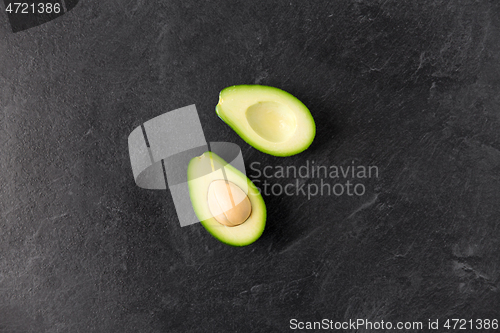 Image of close up of ripe avocado on slate stone background