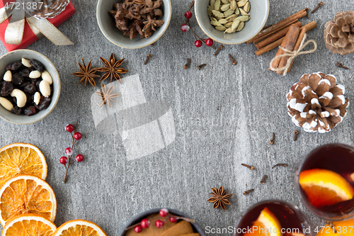 Image of hot mulled wine, orange slices, raisins and spices