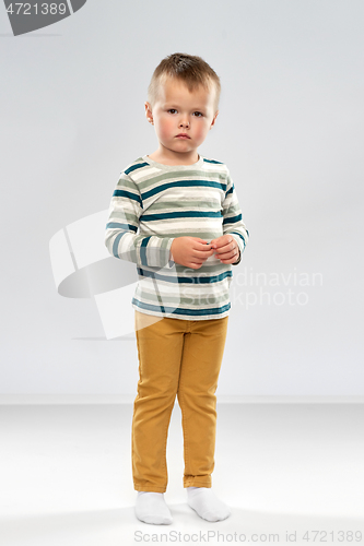 Image of portrait of sad little boy in striped shirt