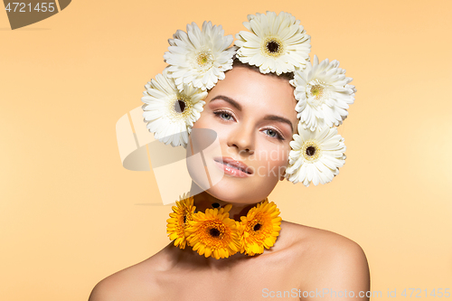 Image of beautiful girl with white and yellow flowers