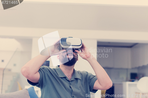 Image of man with beard trying vr glasses