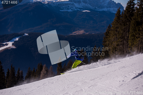 Image of Skier having fun while running downhill