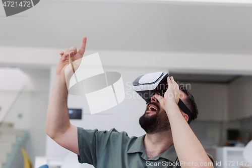 Image of man with beard trying vr glasses