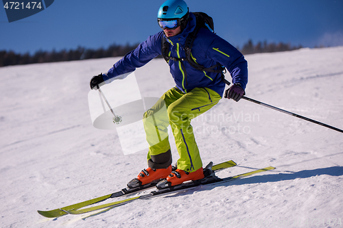 Image of Skier having fun while running downhill