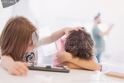 Image of cute little brother and sister having fun at home