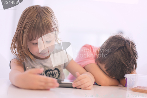 Image of cute little brother and sister having fun at home