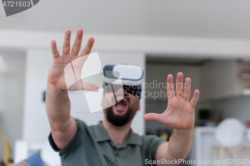 Image of man with beard trying vr glasses