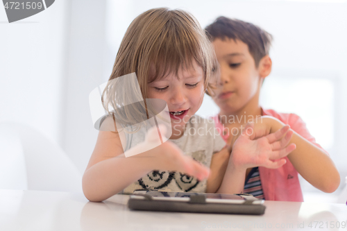 Image of cute little brother and sister having fun at home