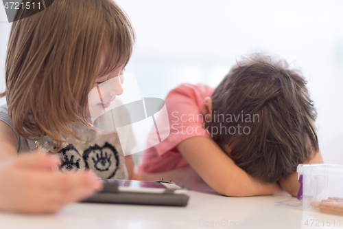 Image of cute little brother and sister having fun at home