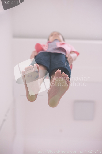 Image of little boy standing on transparent glass floor