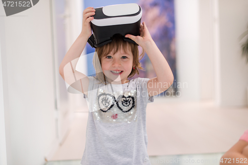 Image of little girl at home wearing vr glasses