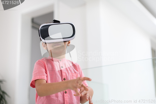 Image of kid at home playing games on vr glasses
