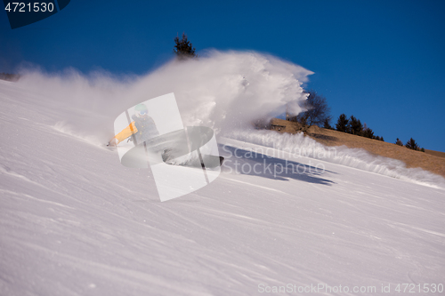 Image of snowboarder crashes while carving down