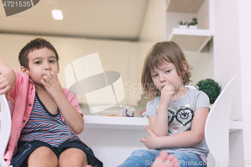 Image of cute little brother and sister at home