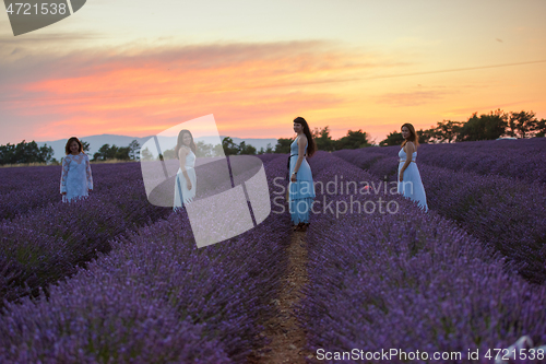 Image of group of famales have fun in lavender flower field