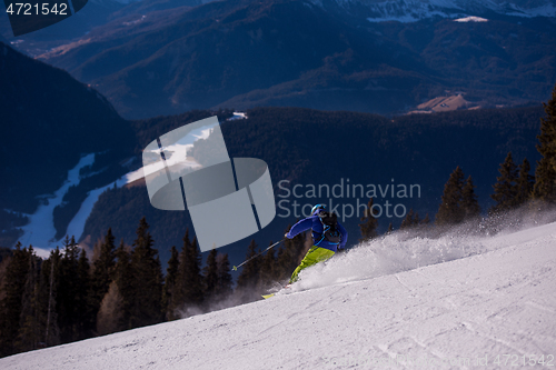 Image of Skier having fun while running downhill