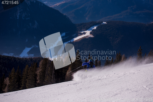 Image of Skier having fun while running downhill