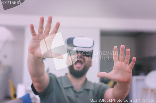 Image of man with beard trying vr glasses