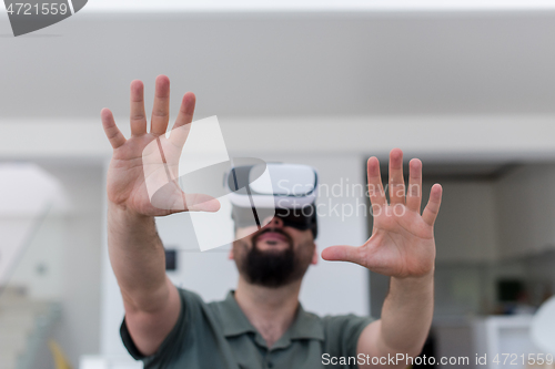 Image of man with beard trying vr glasses