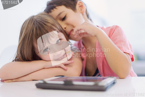 Image of cute little brother and sister having fun at home