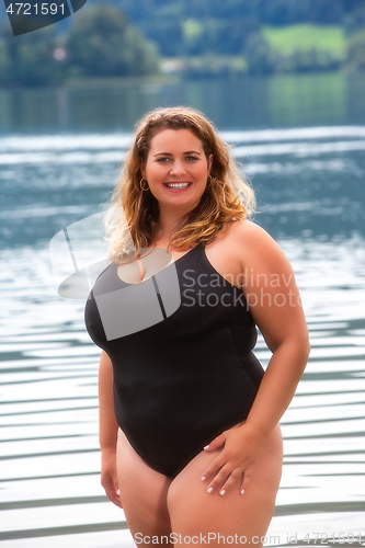 Image of Laughing Curvy Model in swimsuit