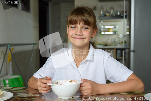 Image of The girl cheered up after eating soup at lunch