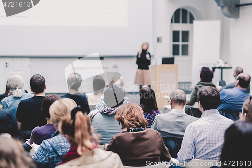 Image of Female speaker giving presentation on business conference.