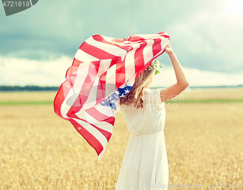 Image of happy woman with american flag on cereal field