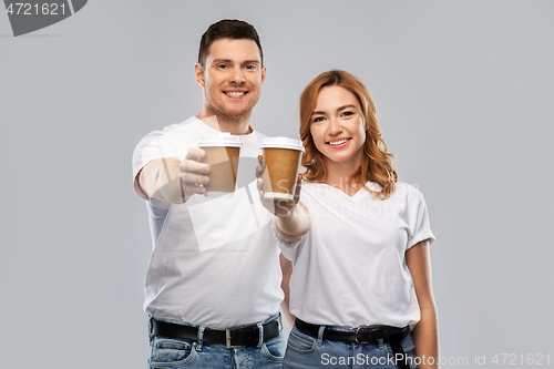 Image of portrait of happy couple with takeaway coffee cups