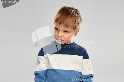 Image of portrait of gloomy little boy in striped pullover