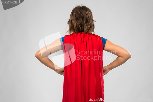 Image of back view of young woman in red superhero cape