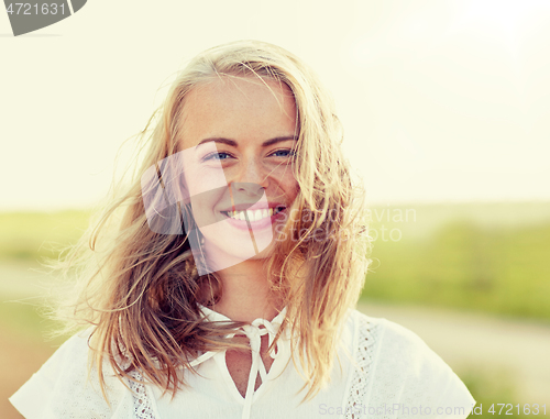 Image of close up of happy young woman in white outdoors