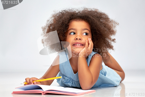 Image of happy little african american girl with sketchbook