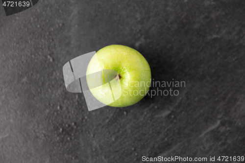 Image of ripe green apple on slate stone background