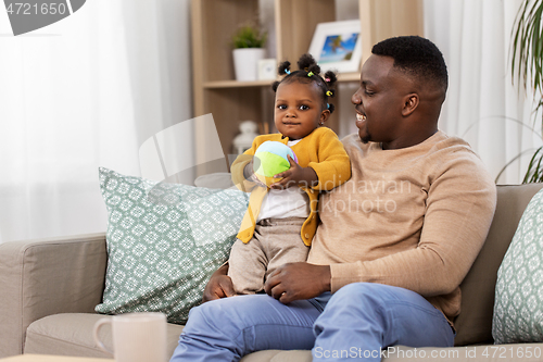 Image of happy african american father with baby at home