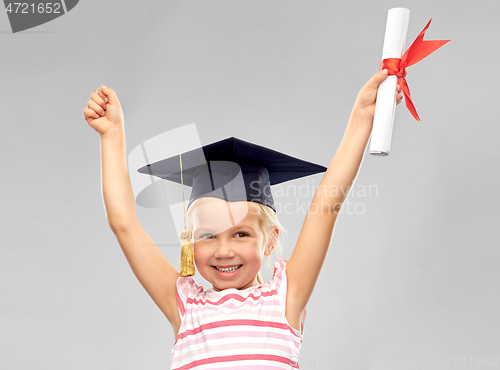 Image of happy little girl in mortarboard with diploma