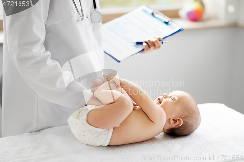 Image of female pediatrician doctor with baby at clinic