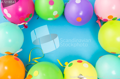 Image of party balloons and confetti on blue background