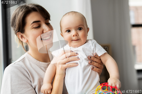 Image of happy young mother holding little baby daughter