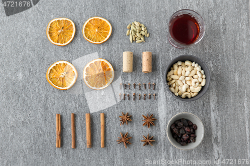 Image of hot mulled wine, orange slices, raisins and spices