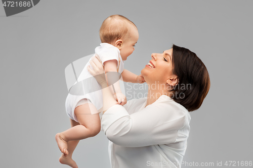 Image of happy middle-aged mother with little baby daughter