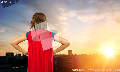 Image of woman in superhero cape over tallinn city