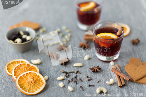 Image of hot mulled wine, orange slices, raisins and spices