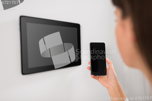 Image of woman using tablet computer and smartphone