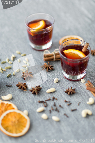 Image of hot mulled wine, orange slices, raisins and spices